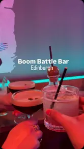 A short, energetic video showcasing a visit to Boom Battle Bar in Edinburgh, highlighting the combination of competitive socialising games like darts and mini golf with casual dining and cocktails.