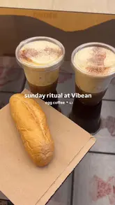 A short, aesthetic reel showcasing a visit to Vibean, a Vietnamese specialty coffee shop. The video features the exterior, the interior decor, and close-ups of their signature egg coffee being enjoyed with bread.