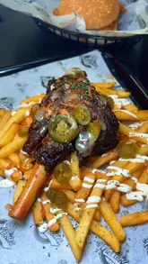 Here are a few SEO-friendly alt text options under 125 characters:

**Option 1 (Descriptive):** 
Brisket mac and cheese, chicken lasagna, and lamb shank on fries from Mr Fries UK in Birmingham.

**Option 2 (Action-oriented):** 
A selection of loaded fries and pasta dishes, including lamb shank and brisket mac and cheese, from Mr Fries UK Birmingham.

**Option 3 (Keyword-focused):** 
Mr Fries UK Birmingham menu featuring brisket mac and cheese, spicy chicken lasagna, and limited edition lamb shank fries.

**Recommendation:** Option 1 is generally the best for accessibility and SEO as it clearly lists the specific dishes featured in the image.
