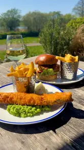Here are a few options for your alt text, keeping it descriptive and SEO-friendly:

*   **Option 1 (Descriptive):** A plate of fish and chips from Salt and Malt overlooking the scenic Chew Valley Lake.
*   **Option 2 (Action-focused):** Enjoying a delicious fish and chips meal at Salt and Malt after a walk at Chew Valley Lake.
*   **Option 3 (Concise):** Freshly served fish and chips at Salt and Malt restaurant by Chew Valley Lake.

**Pro-tip:** Google prefers descriptive text that helps visually impaired users understand what is happening in the photo, so Option 1 or 2 are usually best for SEO!