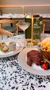 Here are a few options for your alt text, depending on what is most visible in the image:

**Option 1 (Focus on the food - best for SEO):**
Delicious cured salmon, prawns, monkfish, and sirloin steak dinner at Hazel restaurant in Glasgow.

**Option 2 (Focus on the venue/vibes):**
Stylish table setting at Hazel restaurant in Glasgow, perfect for a romantic date night dinner.

**Option 3 (General/Lifestyle):**
Gourmet dinner dishes served at Hazel, a popular restaurant and date night spot in Glasgow city centre.

**SEO Tip:** I have included the location (**Glasgow**) and the restaurant name (**Hazel**), as these are the most important keywords for local search visibility.
