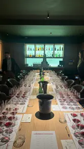 A short video showcasing an exclusive wine tasting event featuring Vietti Barolo wines at Osteria Bocconcino. The footage pans across a long table set with multiple wine glasses and bottles, followed by a shot of the guests attending the event.
