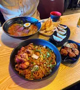 Here are a few options for your alt text, keeping it under 125 characters:

**Option 1 (Descriptive):**
A delicious spread of Japanese food including gyoza, tempura prawns, yakisoba, steak tataki, and cocktails at Maki & Ramen.

**Option 2 (Action-oriented):**
Spread of chicken gyoza, tempura, ramen, and cocktails enjoyed during a meal at Maki & Ramen in Newcastle.

**Option 3 (SEO-focused):**
Japanese food feast featuring chicken gyoza, tempura, and cocktails at Maki & Ramen restaurant in Newcastle.