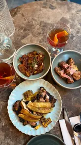 A montage video showcasing the interior, decor, and various Caribbean dishes at The Good Front Room in Dalston, London.