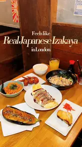 Here are a few options for your SEO alt text, keeping it under 125 characters:

**Option 1 (Descriptive & SEO-focused):**
"Deep fried sesame chicken wings and Japanese dishes served at Tenshi, an authentic izakaya restaurant in London."

**Option 2 (Action-oriented):**
"Close up of delicious Japanese tapas including sesame chicken wings and seared aubergine at Tenshi restaurant in London."

**Option 3 (Concise):**
"Authentic Japanese izakaya dishes like tonpeiyaki and chicken wings at Tenshi restaurant in London."

**SEO Tip:** I included "Japanese izakaya," "Tenshi," and "London," as these are the strongest keywords for your post.