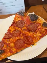 Here are a few options for your SEO alt text, keeping it under 125 characters:

*   **Option 1 (Descriptive):** Freshly baked artisanal pizza served at Original Vincenzo's Pizza in London.
*   **Option 2 (Action-oriented):** Close-up of a delicious, authentic stone-baked pizza at Original Vincenzo's Pizza restaurant.
*   **Option 3 (Simple & SEO-focused):** A piping hot pizza on a table at Original Vincenzo's Pizza, a top-rated London pizza spot.

**SEO Tip:** I recommend **Option 1 or 3** as they include both the restaurant name and the location, which helps with local search visibility.