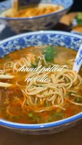 A short, energetic review of a new hand-pulled noodle spot in Cambridge, featuring shots of the chef preparing the noodles, close-ups of the dishes, and the creator trying the food.