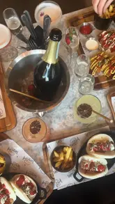 This reel promotes a bottomless brunch collaboration between Tipsy Chef and Baluga. It features a montage of the venue's interior, the street food offerings (bao buns, burgers, fries), and a variety of cocktails, all set to upbeat music with text overlays explaining the offer.