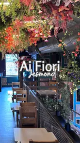 Here are a few options for your alt text, depending on what is most prominent in your photo:

**Option 1 (Focus on the food):**
Fresh, wood-fired Neapolitan pizza with airy crusts served at Ai Fiori restaurant in Jesmond, Newcastle.

**Option 2 (Focus on the atmosphere/design):**
Industrial-chic interior with foliage and modern lighting at Ai Fiori, a new Italian restaurant in Jesmond.

**Option 3 (Comprehensive):**
Authentic Neapolitan pizza and cocktails inside the stylish, industrial-designed Ai Fiori restaurant in Jesmond.

**SEO Tip:** I recommend **Option 3** as it hits your primary keywords (Italian restaurant, Ai Fiori, Jesmond, Neapolitan pizza) while staying under the 125-character limit.