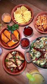 A visually appealing food showcase reel featuring a wide variety of Indian and Indo-Chinese dishes at a new restaurant in Dundee, highlighting the diverse menu and presentation.
