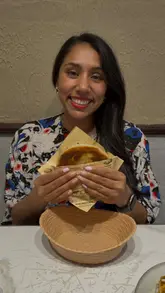 A creator visits Greedy Sheep, showcasing a variety of Chinese dishes including a Chinese beef burger, dumplings, noodles, and rice.