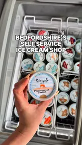 A short, first-person tour of 'The Ice Cube' at Riverside Dairy, a self-service ice cream shop in Bedfordshire. The video highlights the variety of ice cream and sorbet flavours available, the payment process, and the outdoor seating area.