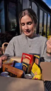 A creator unboxes a 'Hello Yummy Box' subscription box, showcasing various healthy snacks, drinks, and supplements included in the limited edition package.