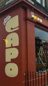 A vlog-style review of Little Capo in Edinburgh, featuring the restaurant's interior, menu, cocktails, and a selection of small plates including zucchini fries and pasta.