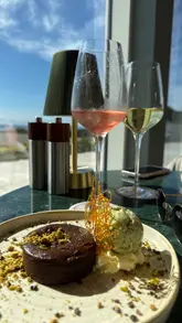 A vlog-style review of Tides restaurant at Seamill Hydro Hotel, showcasing the food, drinks, and coastal views. The creator highlights the quality of the dishes and the scenic setting.