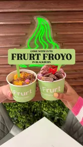 A couple visits a self-serve frozen yogurt shop in Blackburn, showcasing the process of dispensing yogurt, selecting from a wide variety of toppings, weighing the final product, and enjoying their creations.