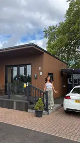 Here are a few options for your alt text, keeping it descriptive and SEO-friendly:

**Option 1 (Descriptive & Search-focused):**
Couple enjoying a relaxing staycation at Arranview Lochside Lodges near Glasgow.

**Option 2 (Lifestyle & Location):**
A cozy lodge interior at Arranview Lochside Lodges, perfect for a romantic Scottish getaway.

**Option 3 (Action-oriented):**
Relaxing inside a luxury holiday lodge at Arranview Lochside Lodges during a weekend staycation.

**Tip:** I left out the discount code and social handles, as alt text is primarily used by screen readers to describe the *visual* content of the image to users, rather than for promotional copy.