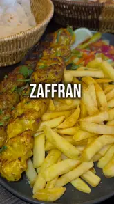 Here are a few options for your alt text, keeping it descriptive and SEO-friendly:

**Option 1 (Descriptive & SEO focused):**
Delicious Persian platter with saffron rice, grilled meats, and flatbread at Zaffran restaurant in Bradford.

**Option 2 (Action & Brand focused):**
A colorful spread of authentic Persian food and grilled kebabs served at Zaffran, the best restaurant in West Yorkshire.

**Option 3 (Concise):**
Table full of traditional Persian dishes including kebabs and saffron rice at Zaffran restaurant in Bradford.

**Best practice tip:** Since alt text is primarily for accessibility, Option 1 is generally the strongest choice as it clearly describes the visual content for screen readers.