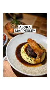 Here are a few options for your SEO alt text, depending on what is in the image:

**Option 1 (Focus on food/dishes):**
A variety of shared small plates including Miso Cod and beef at Alora restaurant in Mapperley.

**Option 2 (Focus on the restaurant vibe):**
Interior view of Alora, a 2 AA Rosette restaurant in Mapperley serving high-quality small plates.

**Option 3 (Focus on drinks/bar):**
Expertly crafted cocktails served at the bar at Alora restaurant in Mapperley.

**Best practice tip:** If the image shows a specific dish, mention that dish by name (e.g., "A spread of small plates including Miso Cod and croquettes at Alora in Mapperley").