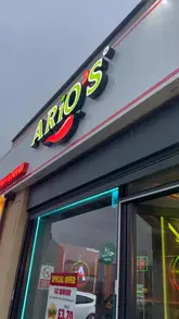 A promotional video for Ario's in Bolton, featuring quick cuts of the restaurant's exterior, interior seating, and various menu items including fried chicken burgers and grilled chicken platters.