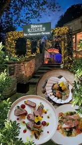 A montage-style video showcasing the dining experience at Brocco Kitchen, featuring close-ups of plated dishes, the restaurant interior, and the chef at work.