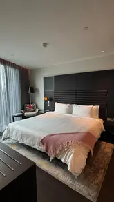 A short, aesthetic video tour of a one-bedroom apartment at the art'otel London Hoxton, highlighting the room's decor, cocktail station, and vinyl record player.