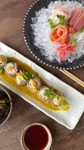 Here are a few options for your SEO alt text, keeping it under 125 characters:

**Option 1 (Descriptive & SEO-focused):**
"Assorted sushi, sashimi, and picanha steak served at Hemisphere restaurant in West Bridgford, Nottingham."

**Option 2 (Action-oriented):**
"Close-up of fresh sushi rolls and a picanha steak hot plate at Hemisphere restaurant, West Bridgford."

**Option 3 (Brand & Location focused):**
"Delicious Japanese tapas including chicken katsu rolls and sashimi at Hemisphere, West Bridgford."

**SEO Tip:** If the image shows a specific spread (like the sashimi on ice), prioritize that in the description to help with image search relevance.