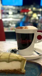 A vlog-style review of a solo visit to Cafe Barbera, featuring coffee and pistachio cheesecake. The creator shares her experience of visiting the venue alone, highlighting the welcoming staff and the quality of the coffee and desserts.