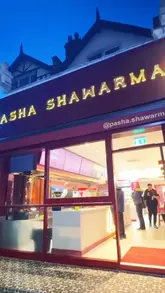 Here are a few options for your SEO alt text, all under 125 characters:

**Option 1 (Focus on the food):**
Juicy chicken shawarma with chips, cheese, and Pasha sauce at Pasha Shawarma in Willesden Green, London.

**Option 2 (Focus on value/location):**
Affordable chicken shawarma and rotisserie at Pasha Shawarma, 61 Walm Ln, London. 

**Option 3 (Descriptive & searchable):**
Delicious chicken shawarma wrap with cheese, chips, and Pasha sauce from Pasha Shawarma restaurant in London.

**SEO Tip:** Always include the location (London/Willesden Green) and the specific dish (Chicken Shawarma) to help your content appear in local search results.