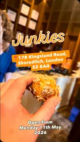 Here are a few options for your SEO alt text, keeping under the 125-character limit:

**Option 1 (Descriptive & SEO-focused):**
Cream-filled chouquettes with pearl sugar topping at Junkies patisserie in Shoreditch, London.

**Option 2 (Action-oriented):**
Close-up of fresh choux pastry bites filled with vanilla cream at Junkies pastry shop on Kingsland Road, London.

**Option 3 (Concise):**
Freshly baked vanilla cream chouquettes at Junkies, a new pastry shop in Shoreditch, London.

**Tip:** Option 1 is generally the best for SEO as it includes the specific product name ("chouquettes"), the business name ("Junkies"), and the location ("Shoreditch, London").