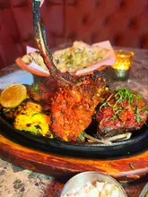 Here are a few options for your alt text, keeping it under 125 characters:

**Option 1 (Descriptive):**
A delicious mixed grill platter with two drinks at Debaga Restaurant in Leeds.

**Option 2 (Social/Review style):**
A £30 mixed grill meal and drinks at Debaga, a favorite Indian restaurant in Leeds.

**Option 3 (SEO-focused):**
Tasty Indian mixed grill platter served with drinks at Debaga restaurant in Leeds.

**SEO Tip:** Option 3 is generally best for search engines as it includes the location, the restaurant name, and the type of food clearly.