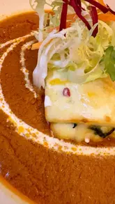 Here are a few SEO-friendly alt text options, depending on what is in the specific image:

**Option 1 (Focus on food):**
"A spread of modern South Asian fusion dishes including dynamite fish and saag paneer lasagne at Peara restaurant."

**Option 2 (Focus on the restaurant/vibe):**
"Stunning modern interior and table setting at Peara, a South Asian fusion restaurant in Leicester."

**Option 3 (Short & descriptive):**
"Delicious variety of creative South Asian fusion dishes served at Peara restaurant in Leicester."

**Best practice tip:** If the image is a close-up of a specific dish (e.g., the Dynamite Fish), use: 
*"Close up of crispy Dynamite fish, a modern South Asian fusion dish served at Peara restaurant."*