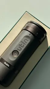 The video demonstrates the use of the Outin portable espresso maker and Fino grinder. It shows the process of grinding beans, loading the portafilter, and brewing a shot of espresso.