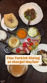 A high-quality, polished montage showcasing a Turkish restaurant in London, featuring close-ups of cocktails, meze, main courses, and desserts, set to music with text overlays describing the items.