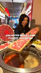 Here are a few options for your SEO alt text (all under 125 characters):

**Option 1 (Focus on the specific dish):**
A long one-metre beef and lamb platter at Dalongyi Hotpot restaurant in London.

**Option 2 (Descriptive for search engines):**
Fresh raw beef and lamb meat platter served at Dalongyi Hotpot, a popular London restaurant.

**Option 3 (Concise and keyword-heavy):**
Close-up of a one-metre meat platter for hotpot dining at Dalongyi London.