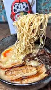 A short, engaging review of Kyoudai Ramen, highlighting their tonkotsu ramen, nanban chicken, and chicken wings. The video features a first-person perspective, showcasing the food and the venue's atmosphere.