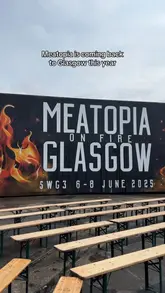 Here are a few options for your alt text, depending on what is in the specific image:

**Option 1 (Focus on the event):**
"Grilling meat over an open flame at the Meatopia food festival in Glasgow."

**Option 2 (Focus on the vibe):**
"People enjoying craft beer and flame-grilled food at the Meatopia festival in Glasgow."

**Option 3 (Action-oriented):**
"Chef cooking skewers over a large charcoal grill at the Meatopia food event in Glasgow."

**SEO Tip:** Alt text should describe the visual content of the image while naturally including keywords (like "Meatopia," "Glasgow," and "food"). Avoid keyword stuffing!