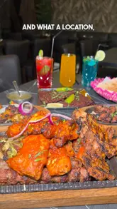 A promotional video for the opening of a new My Peshawar restaurant in Leeds. The video features a tour of the venue's interior and exterior, highlighting the balcony seating and scenic views, followed by a showcase of various dishes including lamb chops, chapli kebabs, butter chicken, and masala fish.