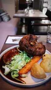 Here are a few options for your alt text, depending on the focus of the image:

**Option 1 (Focus on the meal):**
"A delicious roast beef dinner with stuffed Yorkshire puddings served at Stem restaurant in Hove."

**Option 2 (Descriptive):**
"A high-quality Sunday roast beef meal with vegetables and stuffed Yorkshire puddings at Stem Hove."

**Option 3 (SEO-focused):**
"Sunday roast beef dinner at Stem Hove restaurant featuring large stuffed Yorkshire puddings."

**Best practice tip:** If the image shows a specific person eating or a specific view of the restaurant, be sure to include that detail for better accessibility.