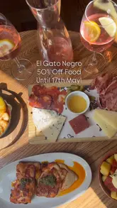 Here are a few options for your SEO alt text, depending on what is most visible in your photo:

**Option 1 (Focus on the food/restaurant):**
Table of delicious Spanish tapas dishes and rose sangria at El Gato Negro restaurant on Castle Street, Liverpool.

**Option 2 (Focus on the experience):**
Close up of gourmet tapas and a glass of rose sangria served at El Gato Negro in Liverpool city centre.

**Option 3 (Concise & SEO-driven):**
A spread of authentic Spanish tapas and wine at El Gato Negro, a popular restaurant on Castle Street, Liverpool.

**Tip:** If you have a specific dish in the photo (like patatas bravas or gambas), swap "Spanish tapas" for the name of that dish to rank even better!