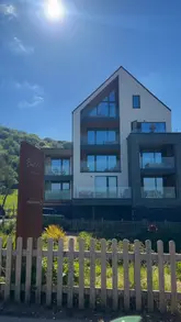 Here are a few options for your SEO alt text, keeping it under 125 characters:

**Option 1 (Descriptive & SEO-focused):**
A luxury stay at Harbour Beach Club in Salcombe, South Devon, featuring stunning coastal views and a relaxing atmosphere.

**Option 2 (Action-oriented):**
Guests enjoying a luxury getaway at the Harbour Beach Club hotel overlooking the waterfront in Salcombe, South Devon.

**Option 3 (Concise):**
Coastal luxury accommodation at the Harbour Beach Club in Salcombe, a premier hotel destination in South Devon. 

**SEO Tip:** I included the location (Salcombe, South Devon) and the hotel name, as these are the most important keywords for local search visibility.