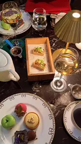 A short, cinematic montage showcasing the Theatreland Afternoon Tea at the Waldorf Hilton. The video features close-ups of delicate pastries, finger sandwiches, and champagne, set against the backdrop of the hotel's elegant interior with live harp music and a cabaret performance.