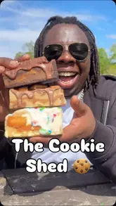 Here are a few options for your SEO alt text (all under 125 characters):

**Option 1 (Descriptive & SEO-friendly):**
A variety of thick, loaded gourmet cookies and bakes inside the honesty-based Cookie Box Co. shed in Shirley.

**Option 2 (Action-focused):**
Customer choosing gourmet cookies and baked treats from the Cookie Box Co. honesty shed on Hargrave Road.

**Option 3 (Short & punchy):**
Selection of loaded cookies and sweet treats at The Cookie Box Co. honesty shed in Shirley, Birmingham.