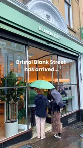 Here are a few options for your SEO alt text, keeping it under 125 characters:

**Option 1 (Descriptive):**
Aesthetic Blank Street coffee shop interior on Park Street in Bristol serving iced matcha drinks.

**Option 2 (Action-focused):**
Customer holding a strawberry and white chocolate matcha latte at the new Blank Street cafe in Bristol.

**Option 3 (SEO-focused):**
Interior of the new Blank Street coffee shop on Park Street, Bristol, featuring colorful matcha lattes. 

**Recommendation:** Go with **Option 1** as it captures both the location and the primary subject matter clearly for search engines.