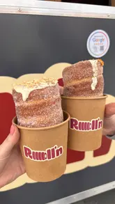 Here are a few options for your SEO alt text (all under 125 characters):

**Option 1 (Focus on the product):**
Freshly baked Chimney Cake with white chocolate filling and almond topping from Roll’n food truck in Liverpool.

**Option 2 (Focus on the location/brand):**
Handheld Chimney Cake dessert from Roll’n, a local food truck serving fresh pastries in Toxteth, Liverpool.

**Option 3 (Descriptive & SEO-rich):**
Delicious warm Chimney Cake with sugar coating and toppings at the Roll’n food truck in Liverpool, L8.

**SEO Tip:** If you are posting this on a blog or website, **Option 1** is generally the best choice as it describes exactly what the viewer is seeing while including the location and brand name.