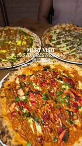 A couple visits the new Shoreditch branch of East West, a restaurant specialising in Indian-Italian fusion. The video features a variety of dishes including butter chicken arancini, saag paneer pizza, and chai tiramisu, alongside creative fusion cocktails. The content highlights the preparation process, the final presentation of the food, and the creators' enjoyment of the meal.