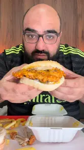 Here are a few options for your SEO alt text, keeping it under 125 characters:

**Option 1 (Focus on description):**
Juicy burger and spicy dipped wings served at Arios on Deane Road in Bolton.

**Option 2 (Focus on location and dish):**
A delicious burger meal from Arios in Bolton, priced at £33 and rated 8/10.

**Option 3 (Concise):**
Big juicy burger and peri wings from Arios restaurant on Deane Road, Bolton.