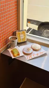 A short, aesthetic montage showcasing the interior and various pastries at Arome bakery in London's Chinatown. The video features close-up shots of tarts, sandwiches, and coffee, highlighting the textures and presentation of the food.