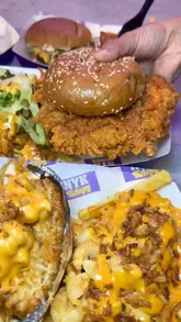 A fast-paced montage showcasing various indulgent fast-food items including burgers, loaded fries, tenders, wings, and desserts at NYK Krispy. The video uses close-up shots to emphasize the texture and appeal of the food, interspersed with brief glimpses of the venue's interior.