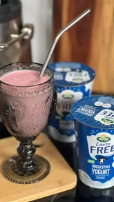 A short recipe tutorial demonstrating how to make a strawberry and vanilla smoothie using Arla LactoFREE Greek Style Yogurt, frozen strawberries, vanilla extract, and oat milk.